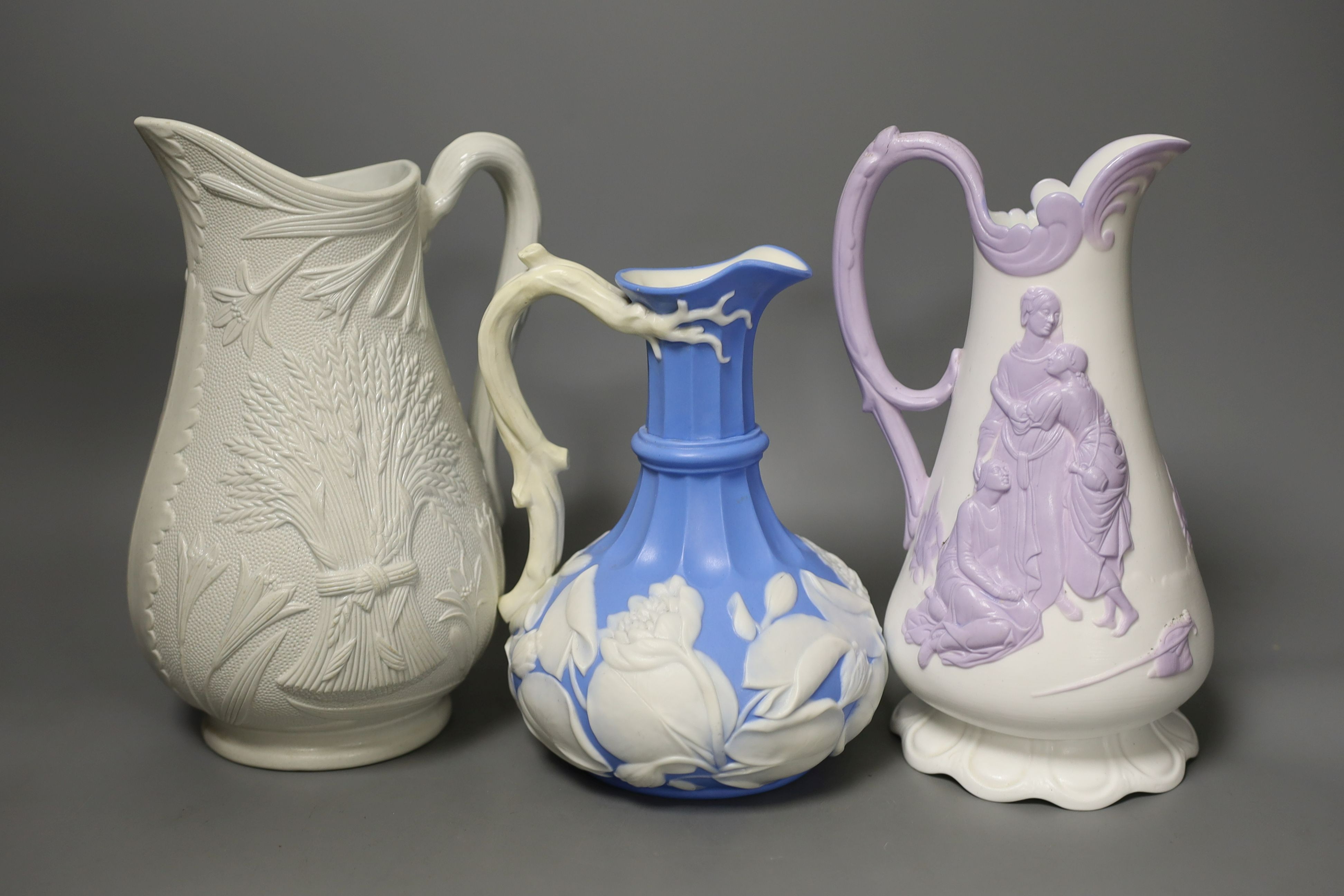 A collection of twelve Victorian relief moulded jugs